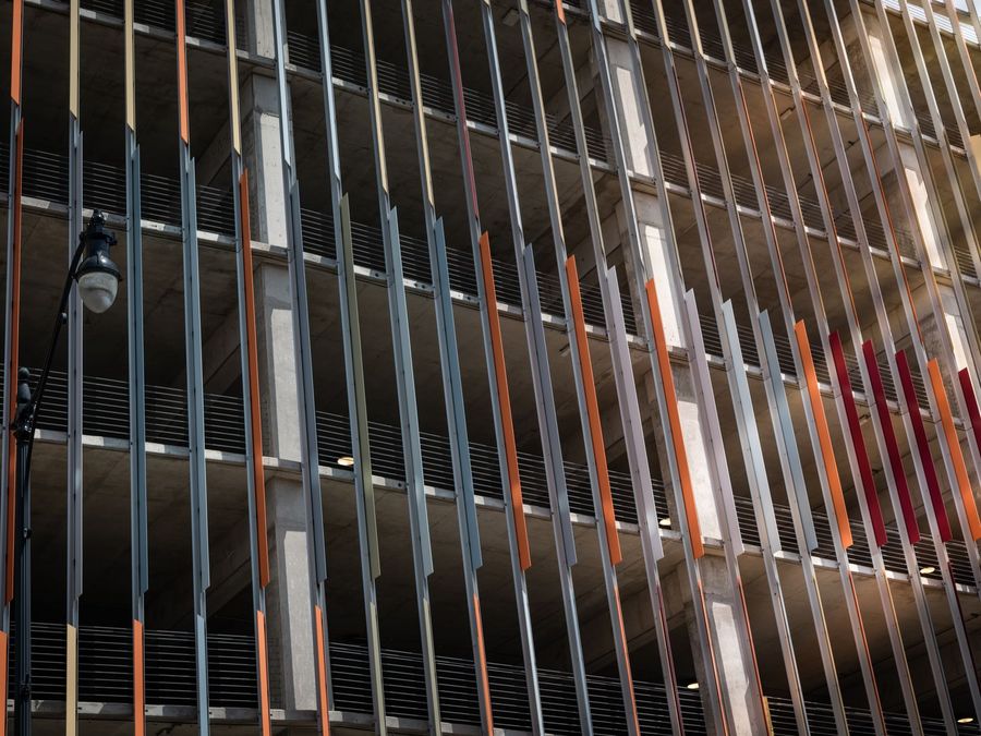 Vertical aluminum slat screening across a modern commercial building frontage
