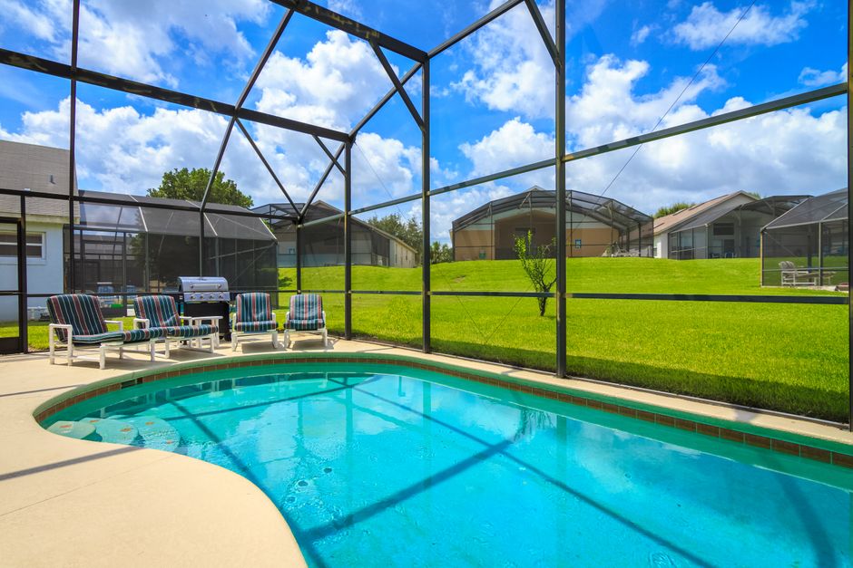 Tall aluminum fence panels enclosing a backyard pool