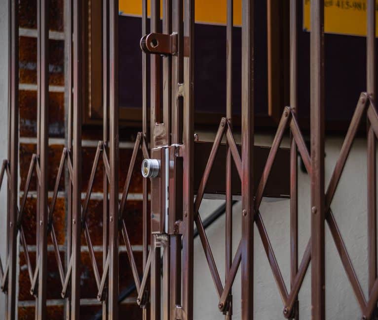 Content Image 1 : Close-up of wrought iron pickets and a locked gate latch