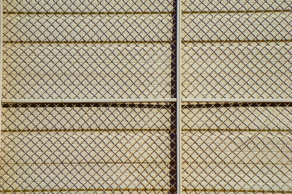 Bronze aluminum fence panel showing powder-coat finish detail