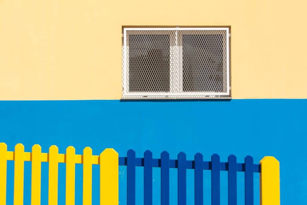 Close-up of narrow picket spacing on an aluminum fence built to contain small dogs