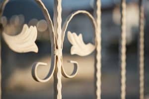 Details of a metal lattice on a fence, selective focus, protection and decoration of plots, idea of security and decor