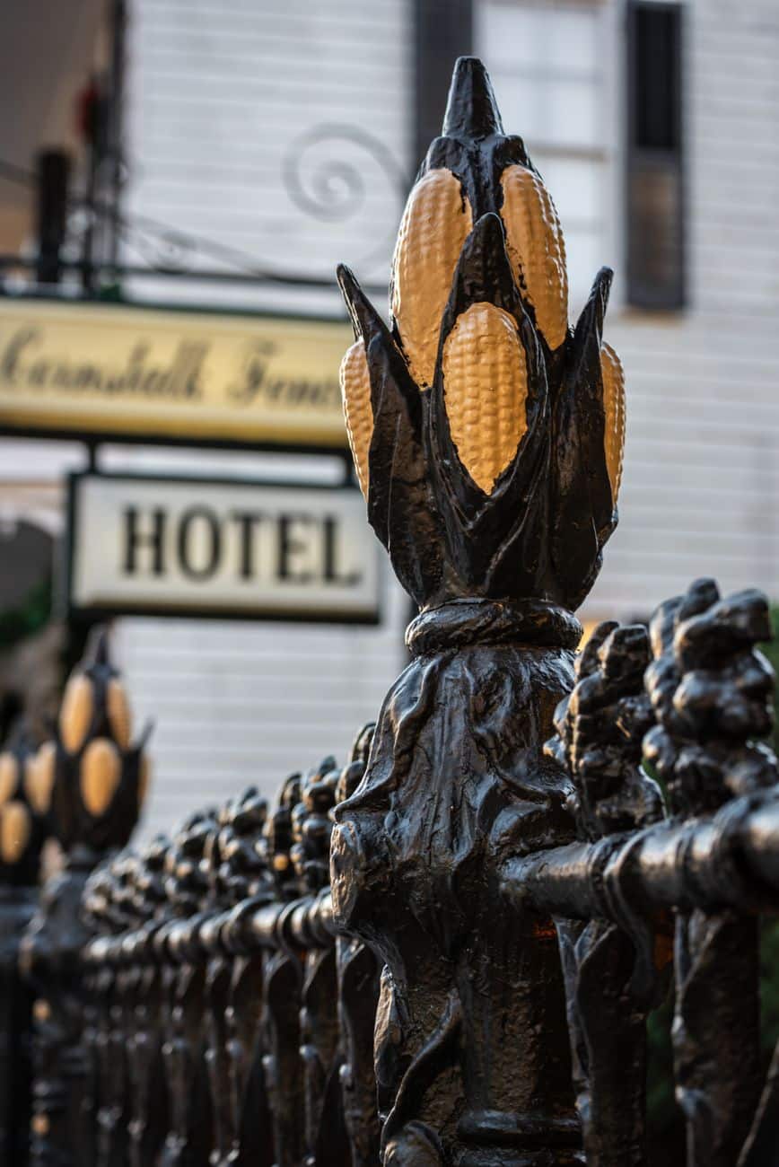 Artistic metal fence with corn design outside a classic hotel in New Orleans, Louisiana.