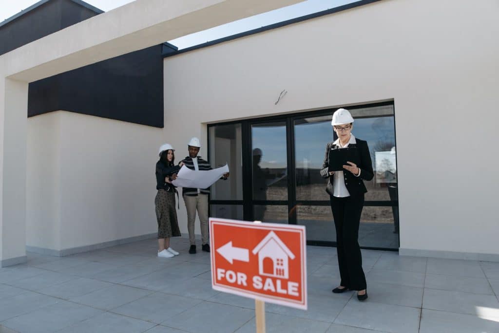 Homeowner and contractor reviewing a written fence estimate on a clipboard