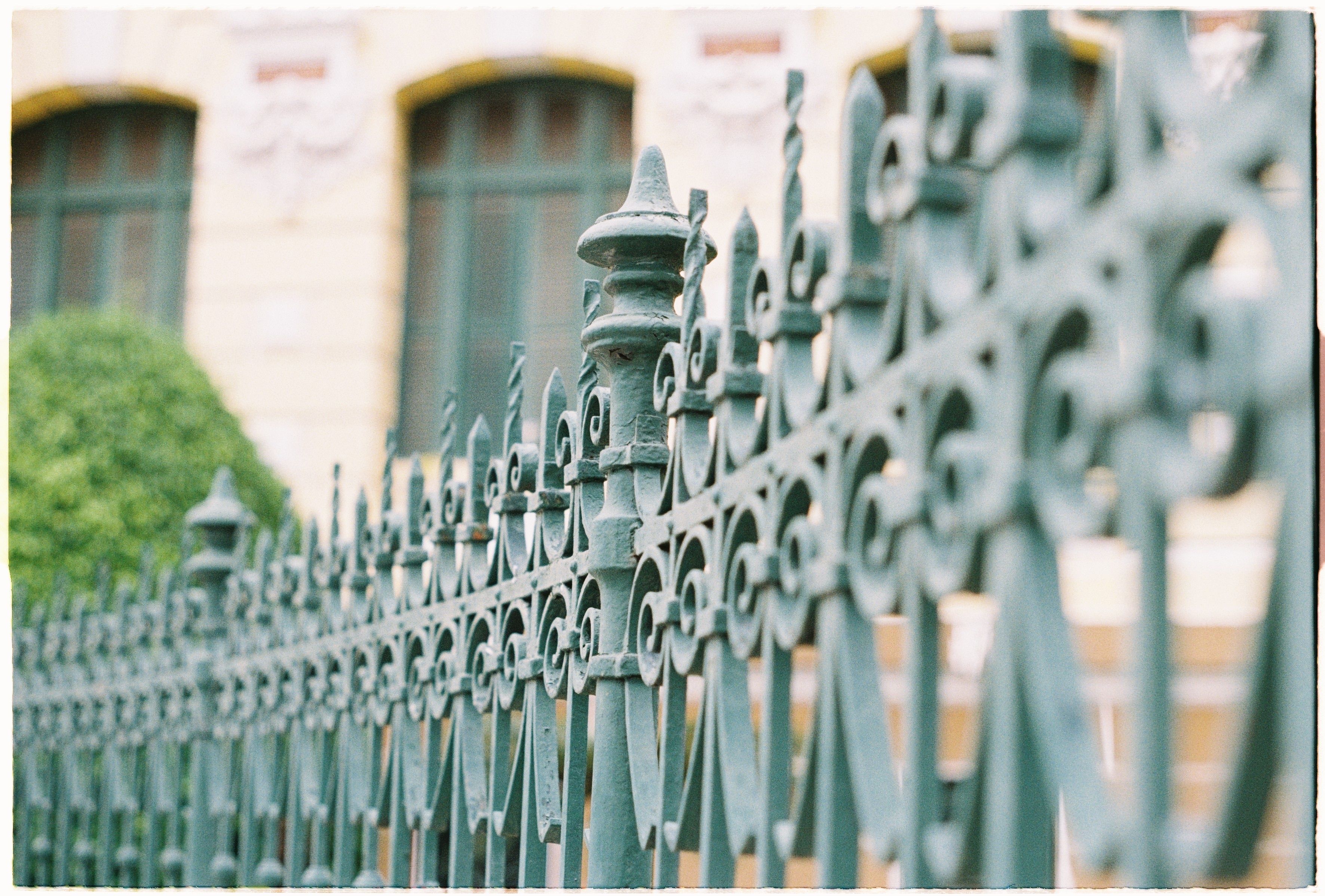 Close-up of ornamental aluminum fence with intricate picket design protecting a New Orleans residential property